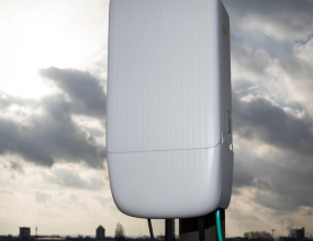Telecom tower with clouds behind it