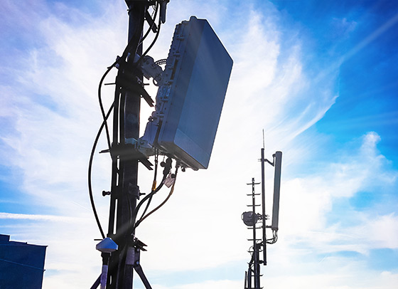 Telecom tower with clouds behind it